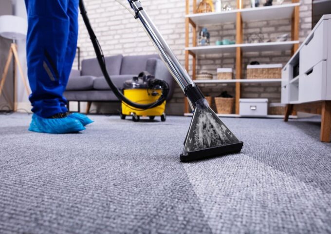 Human Cleaning Carpet In The Living Room Using Vacuum Cleaner At Home